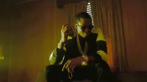 A Man In Sunglasses Is Holding A Bunch Of Money In His Hand GIF