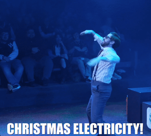 A Man In Suspenders Is Dancing With The Words Christmas Electricity Behind Him GIF
