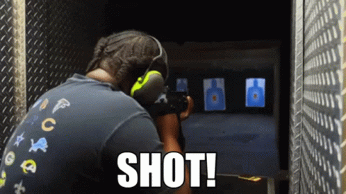 A Man Is Aiming A Gun At A Target And The Word Shot Is On The Bottom Right GIF