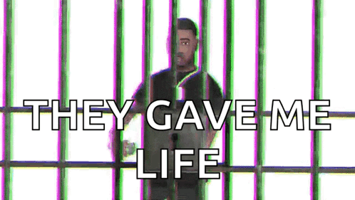 A Man Is Behind Bars With The Words `` They Gave Me Life '' Written Above Him . GIF