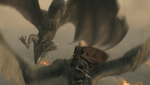 a man is being attacked by a dragon in a scene from a movie