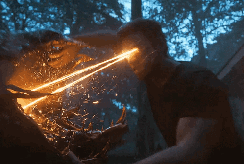 A Man Is Being Attacked By A Monster With A Light Coming Out Of His Eyes GIF