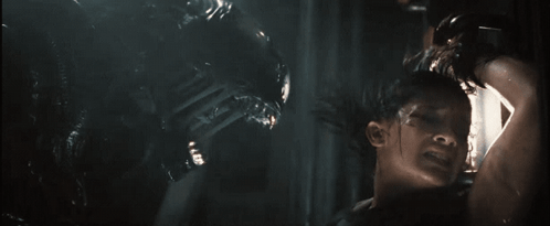 A Man Is Being Attacked By An Alien In A Movie GIF