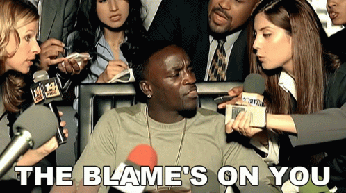 A Man Is Being Interviewed By A Group Of Reporters With The Words The Blame 'S On You Below Him GIF