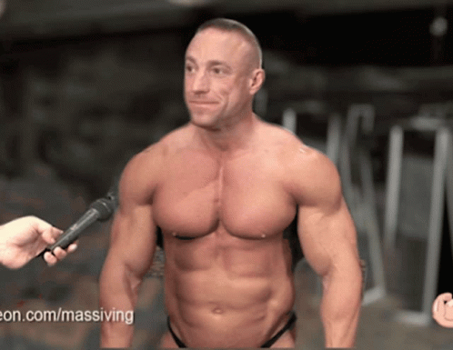 A Man Is Being Interviewed With A Microphone And The Website Www.massiving.com Is Visible GIF