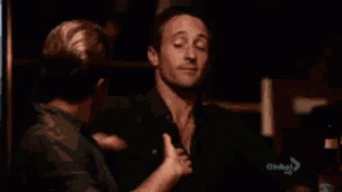 A Man Is Being Touched By Another Man 'S Hand GIF