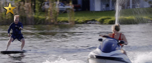 A Man Is Being Towed By A Jet Ski GIF