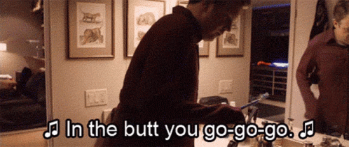 A Man Is Brushing His Teeth In Front Of A Mirror With The Words In The Butt You Go-Go-Go GIF