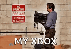 A Man Is Carrying A Camera In Front Of A No Parking Fire Lane Sign GIF