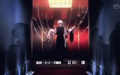 A Man Is Carrying A Woman In His Arms In A Dark Room GIF