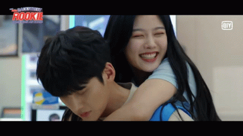 A Man Is Carrying A Woman On His Back With The Word Rookie On The Bottom Left GIF
