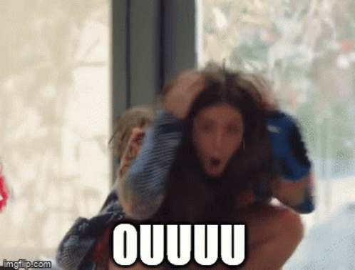 A Man Is Carrying A Woman On His Shoulders And The Woman Is Screaming Ouuuu . GIF