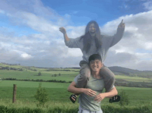 A Man Is Carrying A Woman On His Shoulders And The Woman Is Wearing A Shirt That Says " Abercrombie & Fitch " GIF