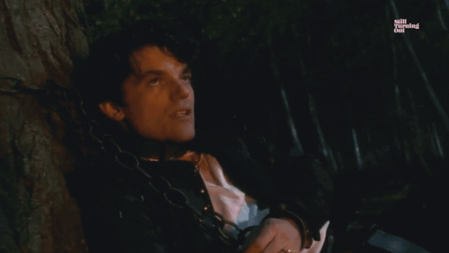 a man is chained to a tree with the words jane is the reason below him