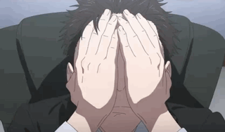 A Man Is Covering His Face With His Hands GIF