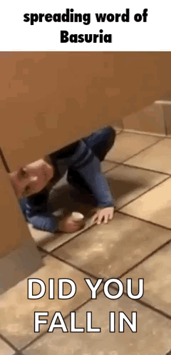 A Man Is Crawling On The Floor In A Bathroom Stall While Holding A Cup . GIF