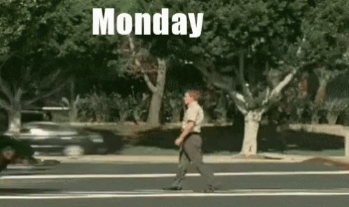 A Man Is Crossing The Street On Monday . GIF