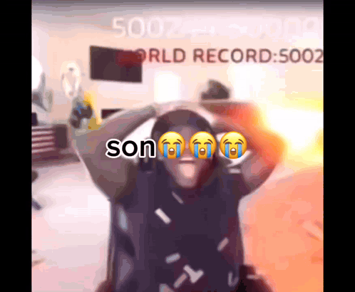 A Man Is Crying In Front Of A Screen That Says Son GIF