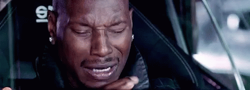 A Man Is Crying While Sitting In A Car Seat . GIF