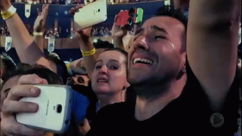A Man Is Crying While Taking A Picture Of Himself With A Samsung Phone GIF