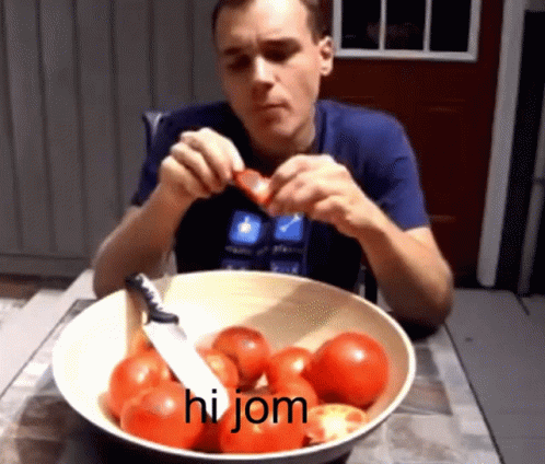 A Man Is Cutting A Tomato In Front Of A Bowl Of Tomatoes That Says Hi Jom On The Bottom GIF
