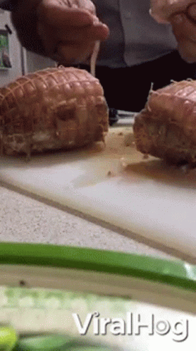 A Man Is Cutting Meat On A Cutting Board With The Words Viralhog Written On The Bottom GIF