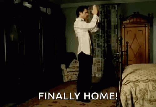 A Man Is Dancing In A Bedroom With The Words `` Finally Home '' Written Above Him . GIF