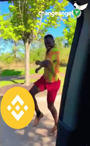 A Man Is Dancing In A Car With A Changeangel Logo Behind Him GIF