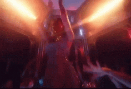 A Man Is Dancing In A Club With His Arms In The Air And A Crowd Behind Him . GIF