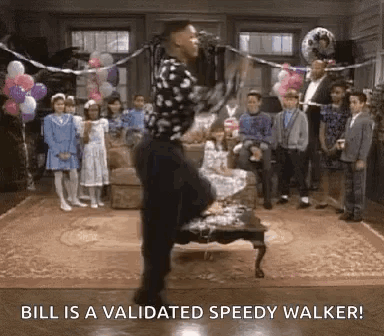 A Man Is Dancing In A Living Room With Balloons And A Group Of Children . GIF