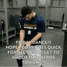 A Man Is Dancing In A Locker Room While Wearing A Blue Shirt And A Hat . GIF