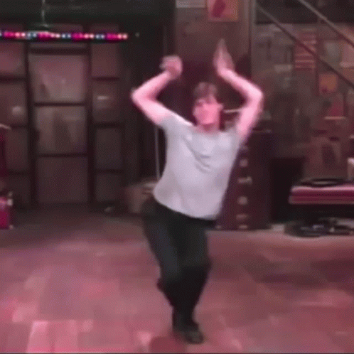 Blurry Photo Of Man Dancing With Arms Outstretched GIF