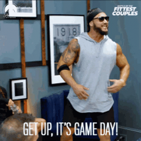 A Man Is Dancing In A Room With The Words Get Up It 'S Game Day Below Him GIF