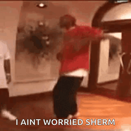 A Man Is Dancing In A Room With The Words I Ain T Worried Sherm Written On The Bottom GIF