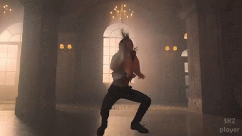 A Man Is Dancing In A Room With The Words Skz Player Visible GIF