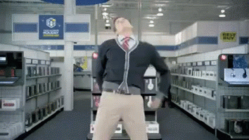 A Man Is Dancing In A Store With A Sign That Says Best Buy In The Background GIF