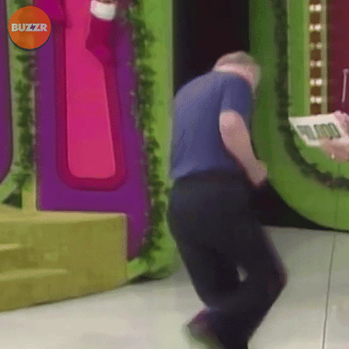 A Man Is Dancing In Front Of A Buzzr Sign GIF