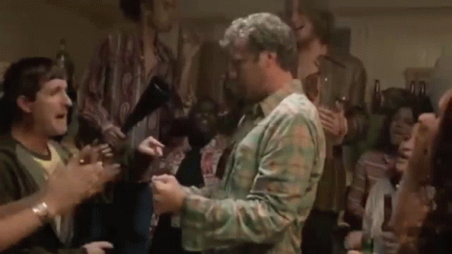 A Man Is Dancing In Front Of A Crowd Of People . GIF