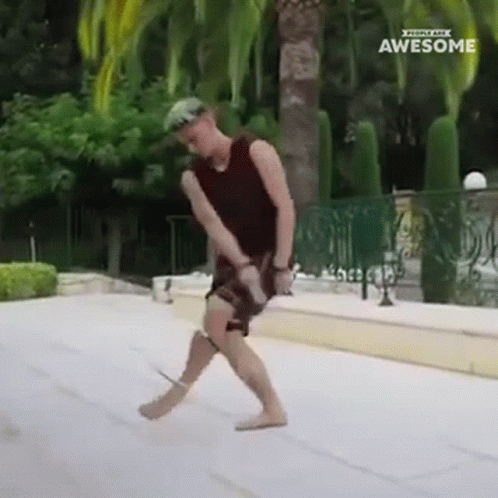 A Man Is Dancing In Front Of A Fence With The Words Awesome On The Bottom Right GIF