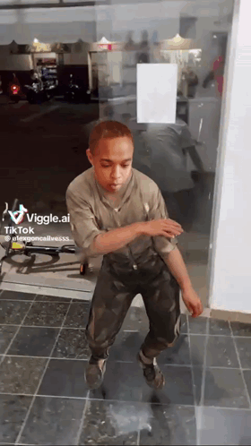 A Man Is Dancing In Front Of A Glass Door With A Tiktok Watermark On The Bottom Right GIF