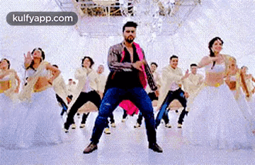 A Man Is Dancing In Front Of A Group Of Dancers In A Dance Studio . GIF