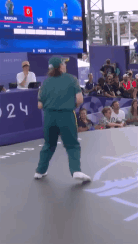A Man Is Dancing In Front Of A Scoreboard That Says 0 Vs 0 GIF