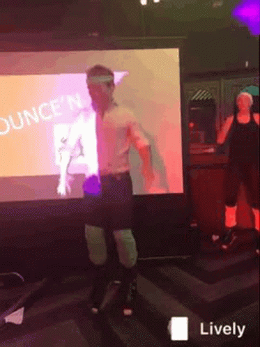 A Man Is Dancing In Front Of A Screen That Says Ounce 'N GIF