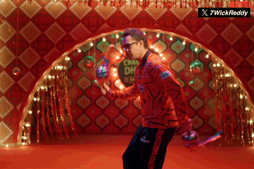 A Man Is Dancing In Front Of A Sign That Says Chaw Dh GIF