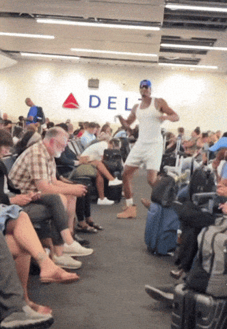 A Man Is Dancing In Front Of A Sign That Says Delta GIF