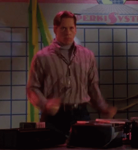 A Man Is Dancing In Front Of A Sign That Says Perki Vs GIF