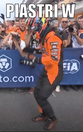 A Man Is Dancing In Front Of A Sign That Says Piastri W GIF