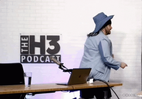 A Man Is Dancing In Front Of A Sign That Says " The H3 Podcast " GIF