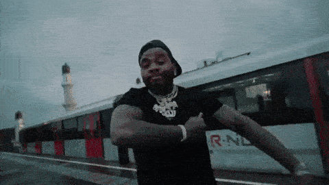A Man Is Dancing In Front Of A Train That Says R-Nl GIF