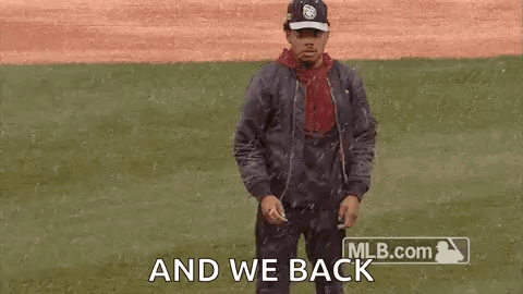 A Man Is Dancing On A Baseball Field While Wearing A Hat And A Jacket . GIF